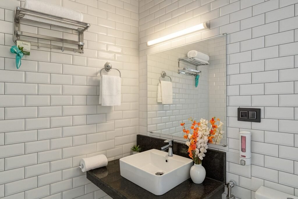 White-tiled bathroom with vessel basin at Oslo Mussoorie by Around Stays