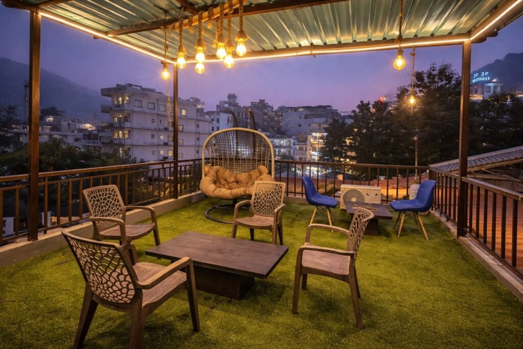 Rooftop terrace with string lights and seating at dusk at Rising Hills by Around Stays