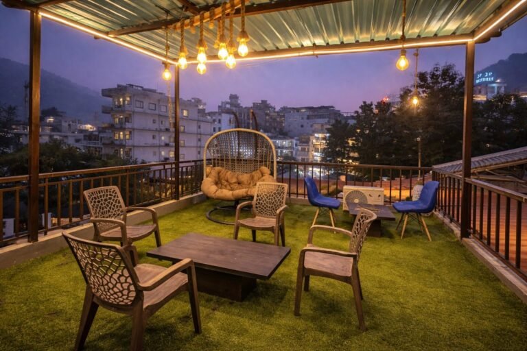 Rooftop terrace with string lights and seating at dusk at Rising Hills by Around Stays