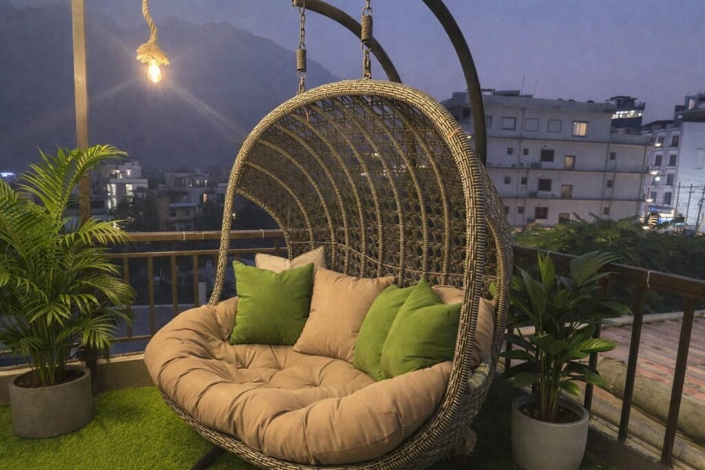 Rattan swing chair on the terrace at Rising Hills by Around Stays