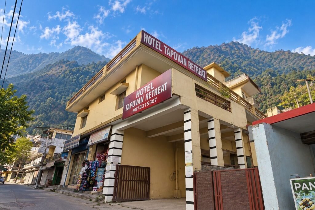 Hotel exterior with mountains behind at Tapovan Retreat by Around Stays