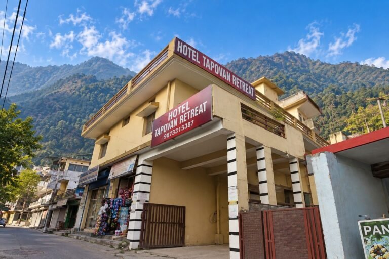 Hotel exterior with mountains behind at Tapovan Retreat by Around Stays