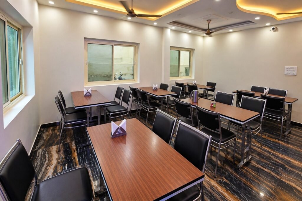 Dining hall with wooden tables at Tapovan Retreat by Around Stays